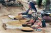 <p>District Kangra, Himachal Pradesh  May 1999<br />
An expert hand at winnowing wheat, a mother-in-law chats with her bahu (daughter-in-law).<br />
Both are busy doing something that has been an intrinsic culture of every household.</p>
